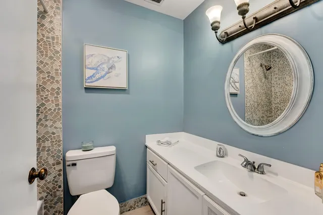 a view of a hallway with furniture and stairs