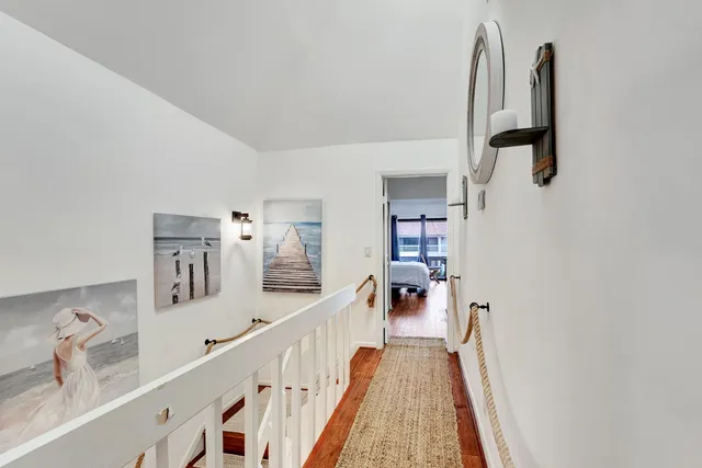a bedroom with two large bed and a large window