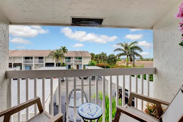a view of a lake with couches chairs
