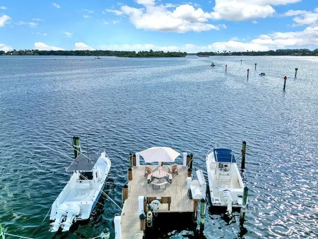 a view of a patio with a dining table and chairs with an umbrella