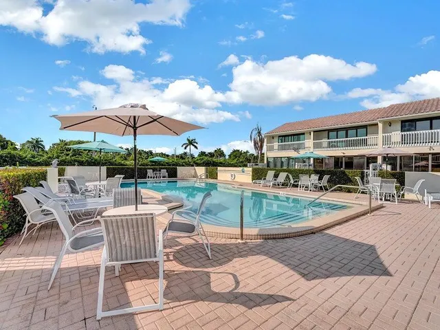 a view of a swimming pool with a lounge chairs