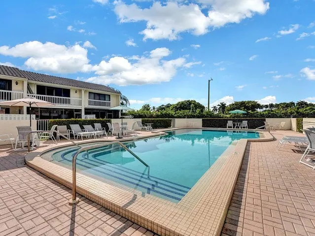 an aerial view of a house with a yard and lake view
