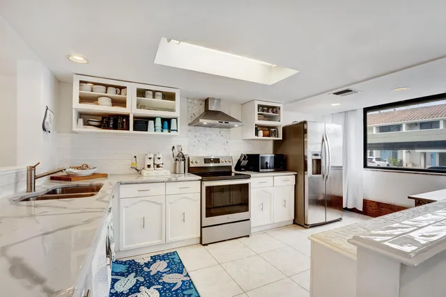 a kitchen with stainless steel appliances granite countertop a stove and a sink