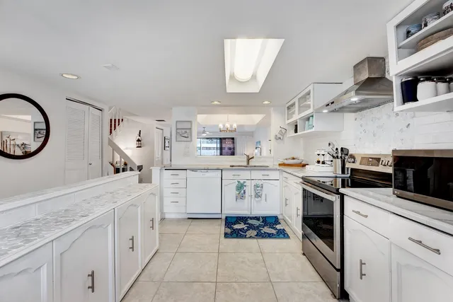a kitchen with cabinets and steel stainless steel appliances