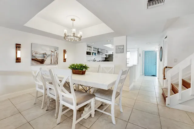 a view of a dining room with furniture and chandelier