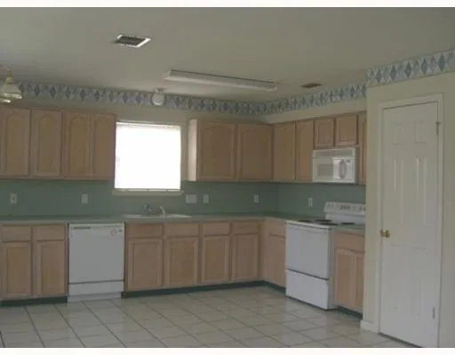 a kitchen with sink and cabinets