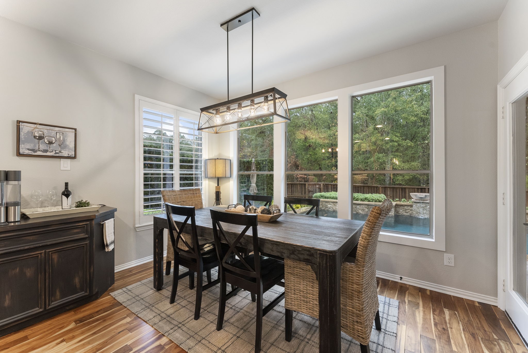 27614 Colin Springs Lane Spring, TX 77386 - Photo 16 of 47 Families will enjoy gathering in this Breakfast Room with peaceful views of the pool and wooded greenbelt, featuring large windows, wood flooring, backyard access, updated lighting, and a custom built-in wine/coffee bar with wine storage!