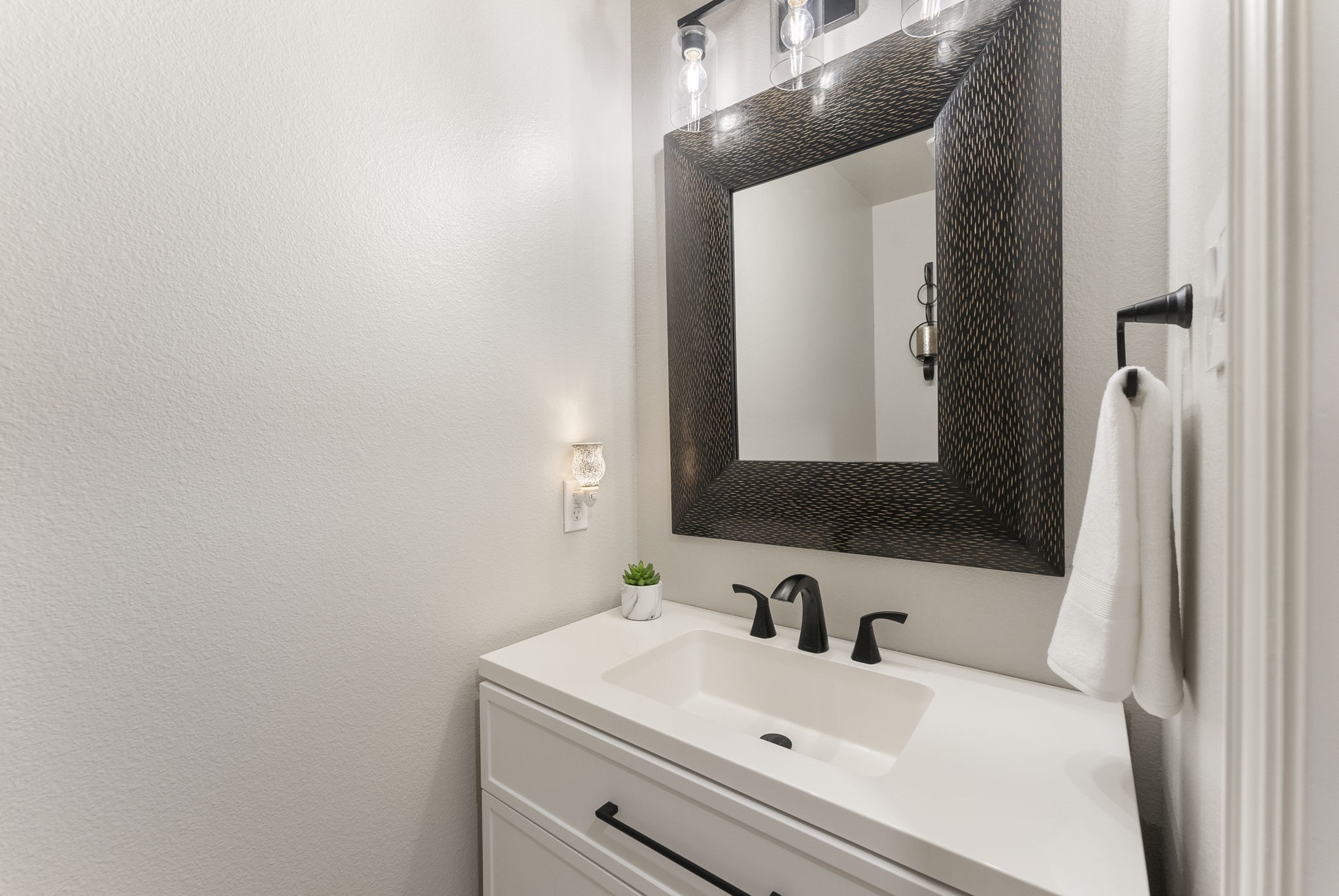 27614 Colin Springs Lane Spring, TX 77386 - Photo 17 of 47 Located off of the main hallway and garage entry, the powder bath features an updated vanity, plumbing/lighting fixtures, cabinetry hardware, and toilet!