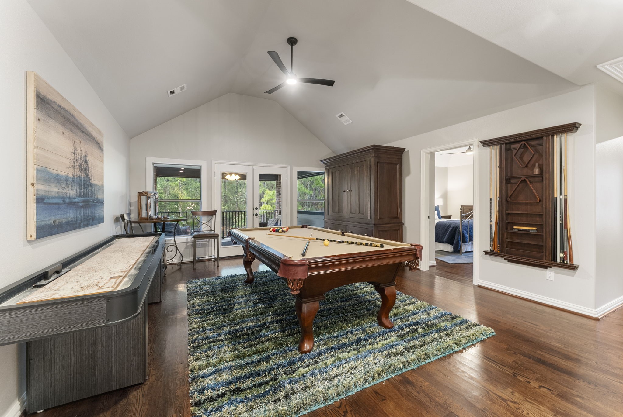 27614 Colin Springs Lane Spring, TX 77386 - Photo 22 of 47 Located at the top of the staircase, this spacious Game Room is an ideal entertainment space featuring wood floors, an elevated ceiling with updated fan, and glass French doors opening to the Balcony.