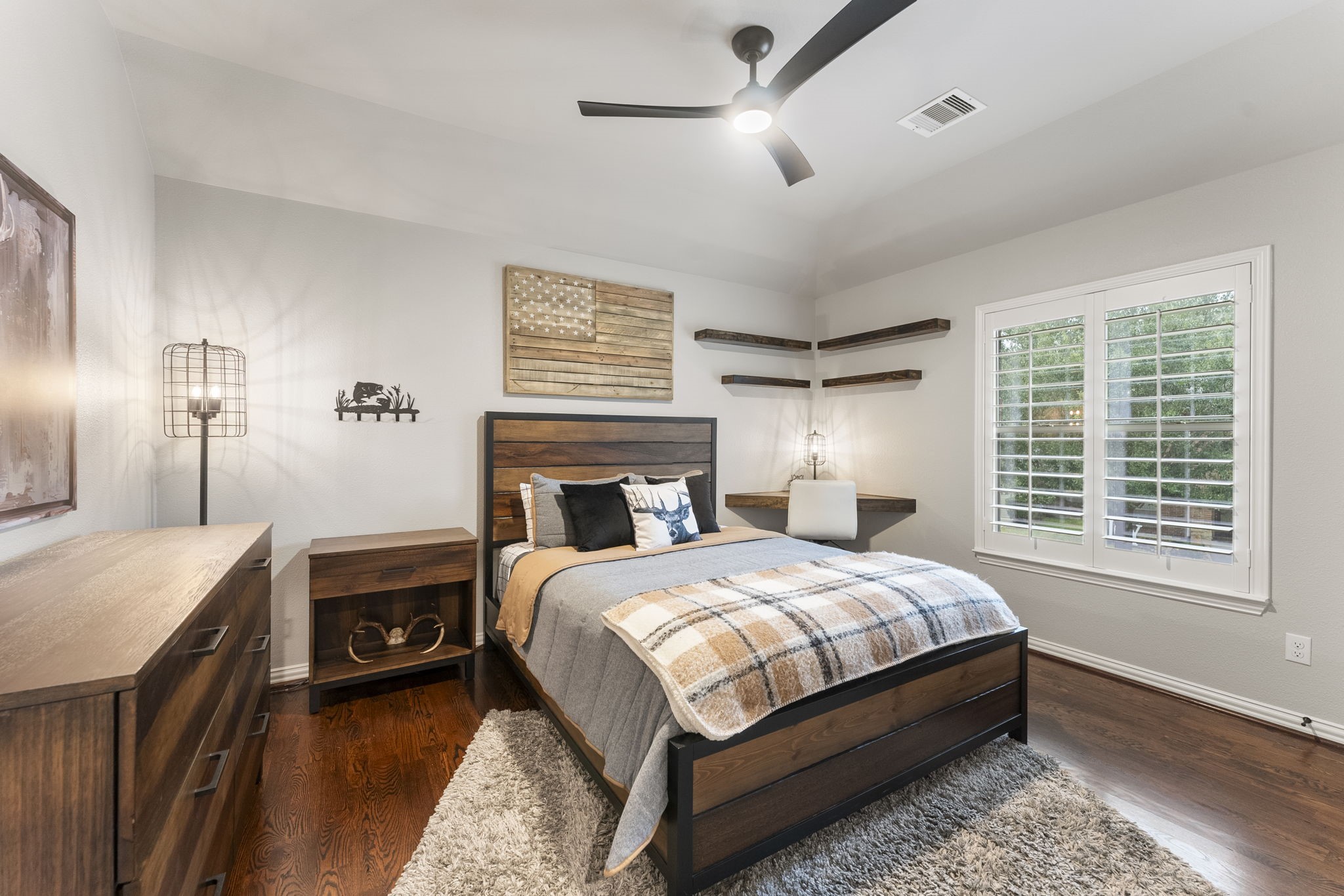 27614 Colin Springs Lane Spring, TX 77386 - Photo 28 of 47 One of 4 upstairs bedrooms with wood flooring, elevated ceiling with updated fan, built-in corner desk and upper shelving, large window with shutters, and a walk-in closet!