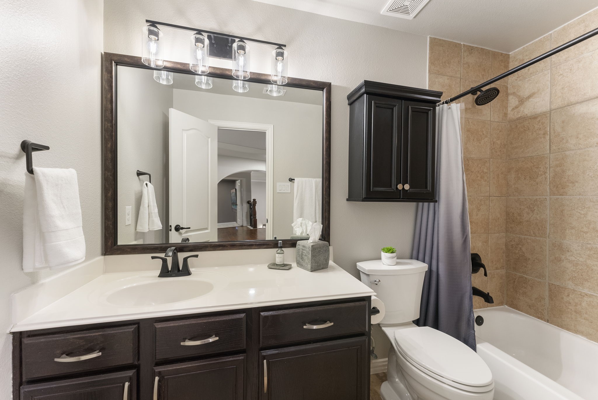 27614 Colin Springs Lane Spring, TX 77386 - Photo 29 of 47 One of the full baths located upstairs with tub/shower combo, large vanity, extra storage above commode, and updated lighting, plumbing fixtures, cabinetry hardware, and toilet!