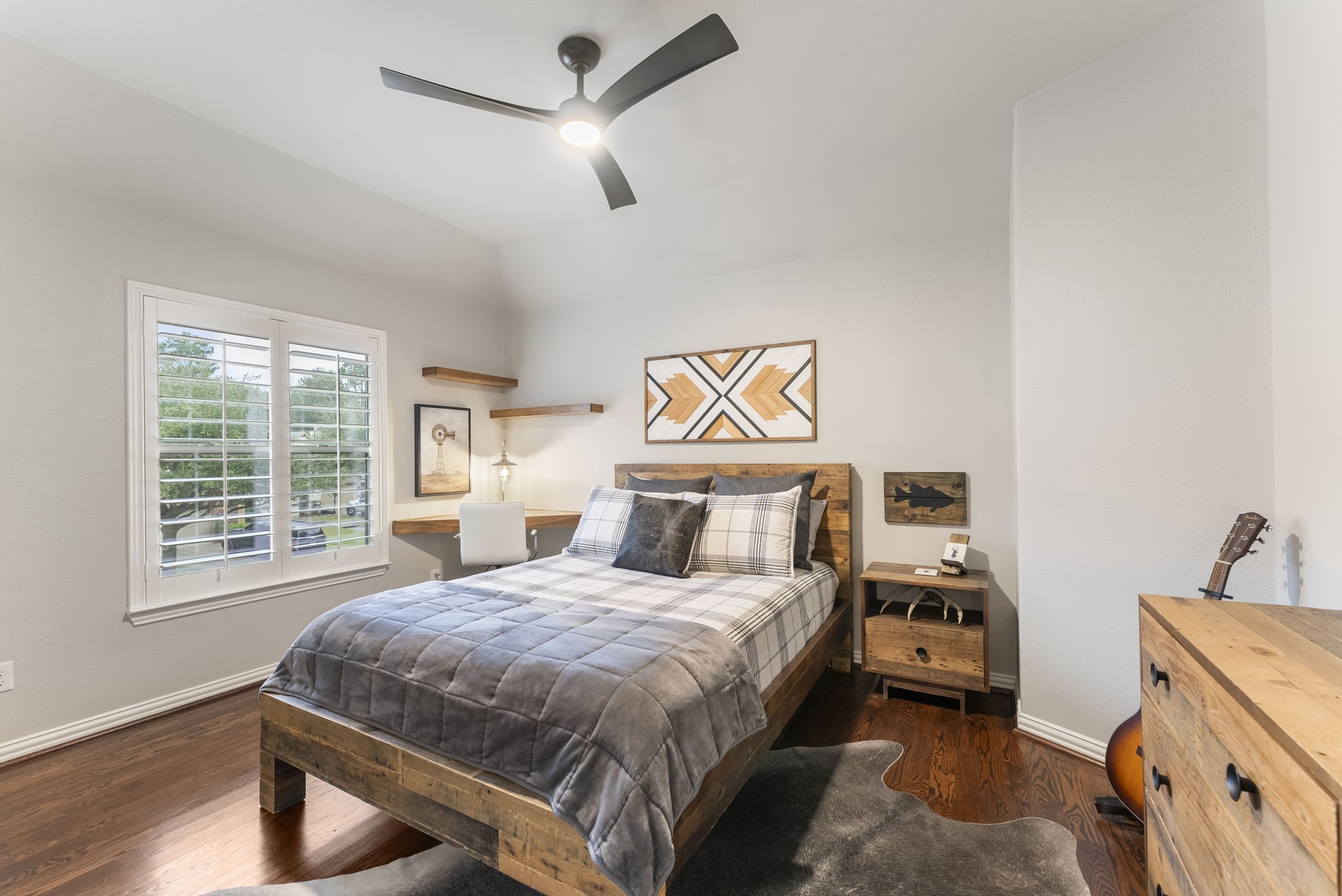 27614 Colin Springs Lane Spring, TX 77386 - Photo 30 of 47 Very spacious secondary bedroom with high ceiling, updated fan, large window, wood flooring, built-in corner desk and shelving, plus a walk-in closet!