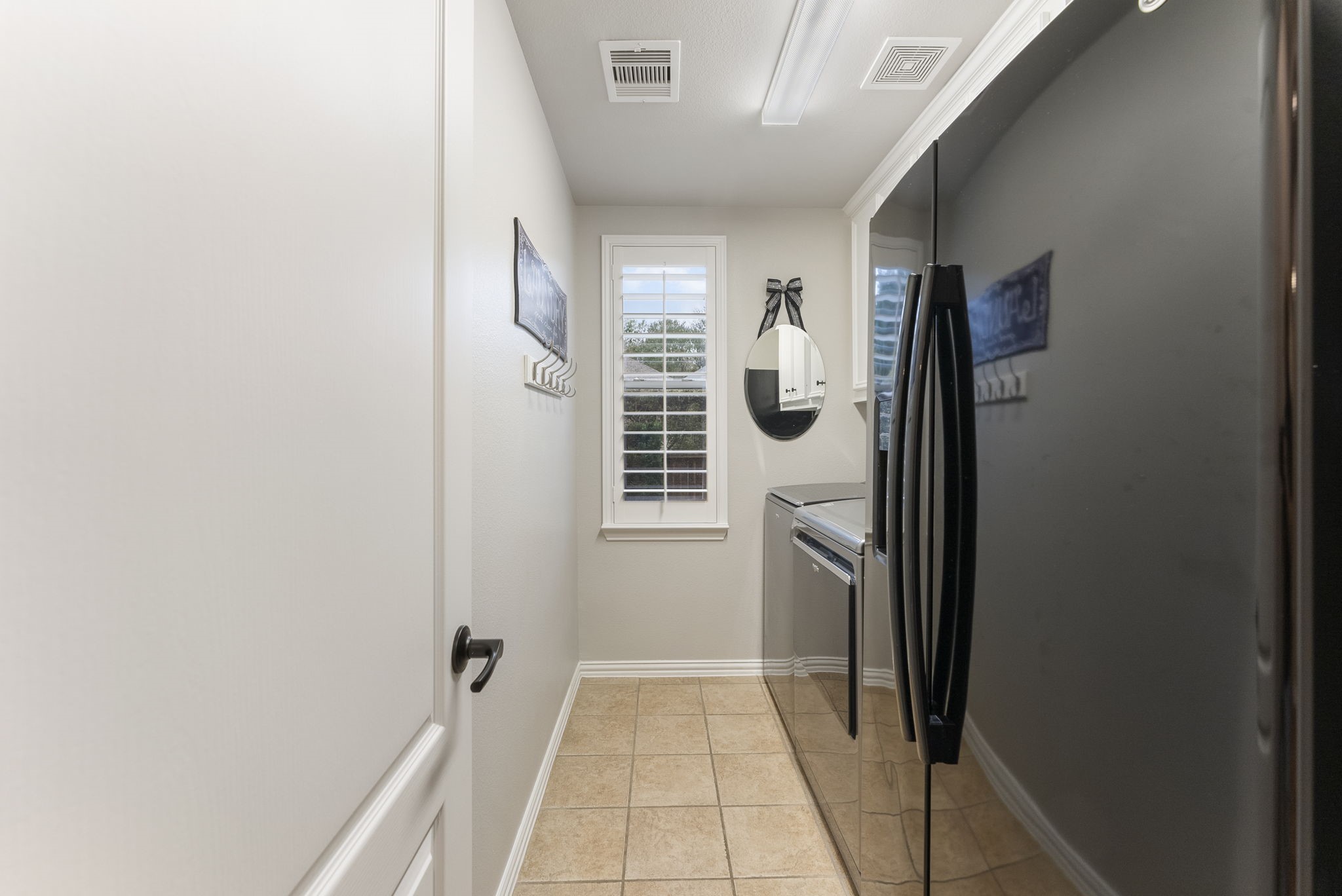 27614 Colin Springs Lane Spring, TX 77386 - Photo 34 of 47 Utility Room nicely positioned across hall from garage entry with room for extra fridge, loads of upper cabinet storage, and window for a touch of natural light.