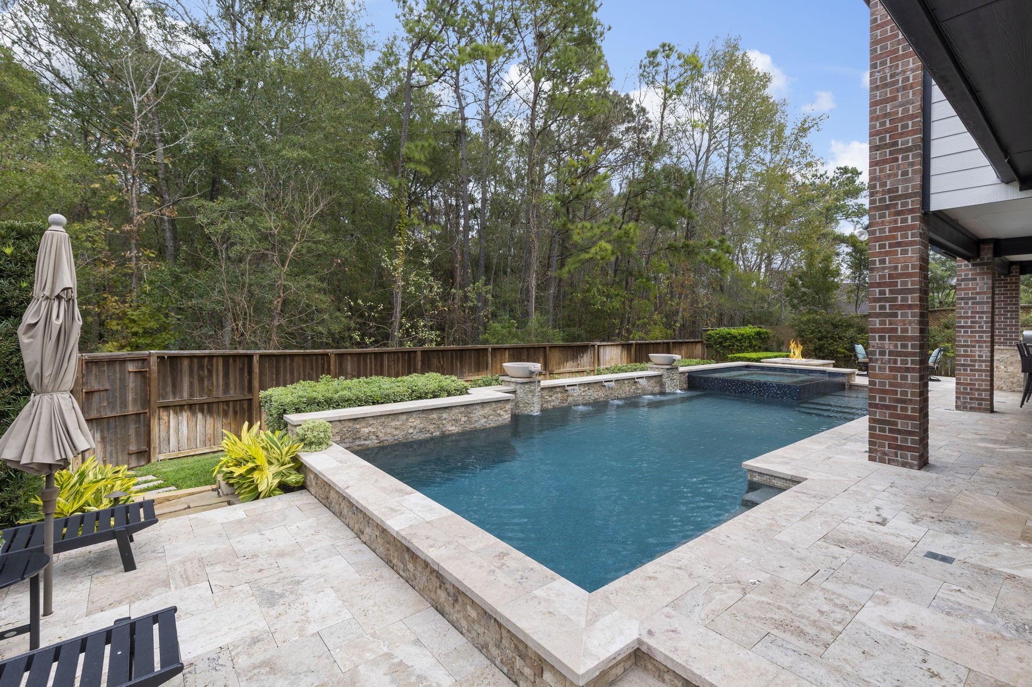 27614 Colin Springs Lane Spring, TX 77386 - Photo 36 of 47 You’ll truly feel like you’re in your own private oasis while enjoying the heated PebbleTec chlorine pool and spa with water features, all set against stunning, serene greenbelt views.