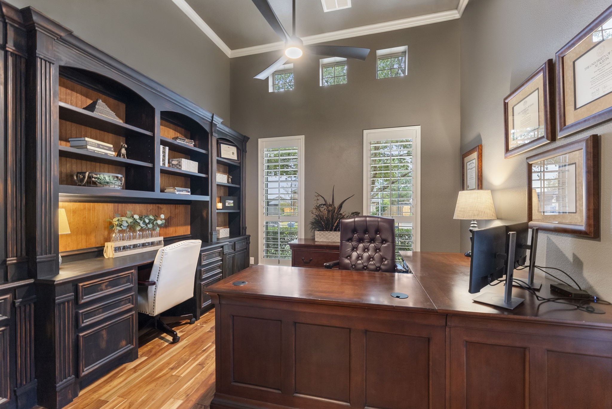 27614 Colin Springs Lane Spring, TX 77386 - Photo 7 of 47 Absolutely stunning Study featuring wood flooring, a wall of custom built-ins with stained wainscoting backdrop accent, high ceiling, crown molding, and tall shuttered windows with upper transoms to provide natural lighting! *Mounted wildlife trophies have been virtually removed.