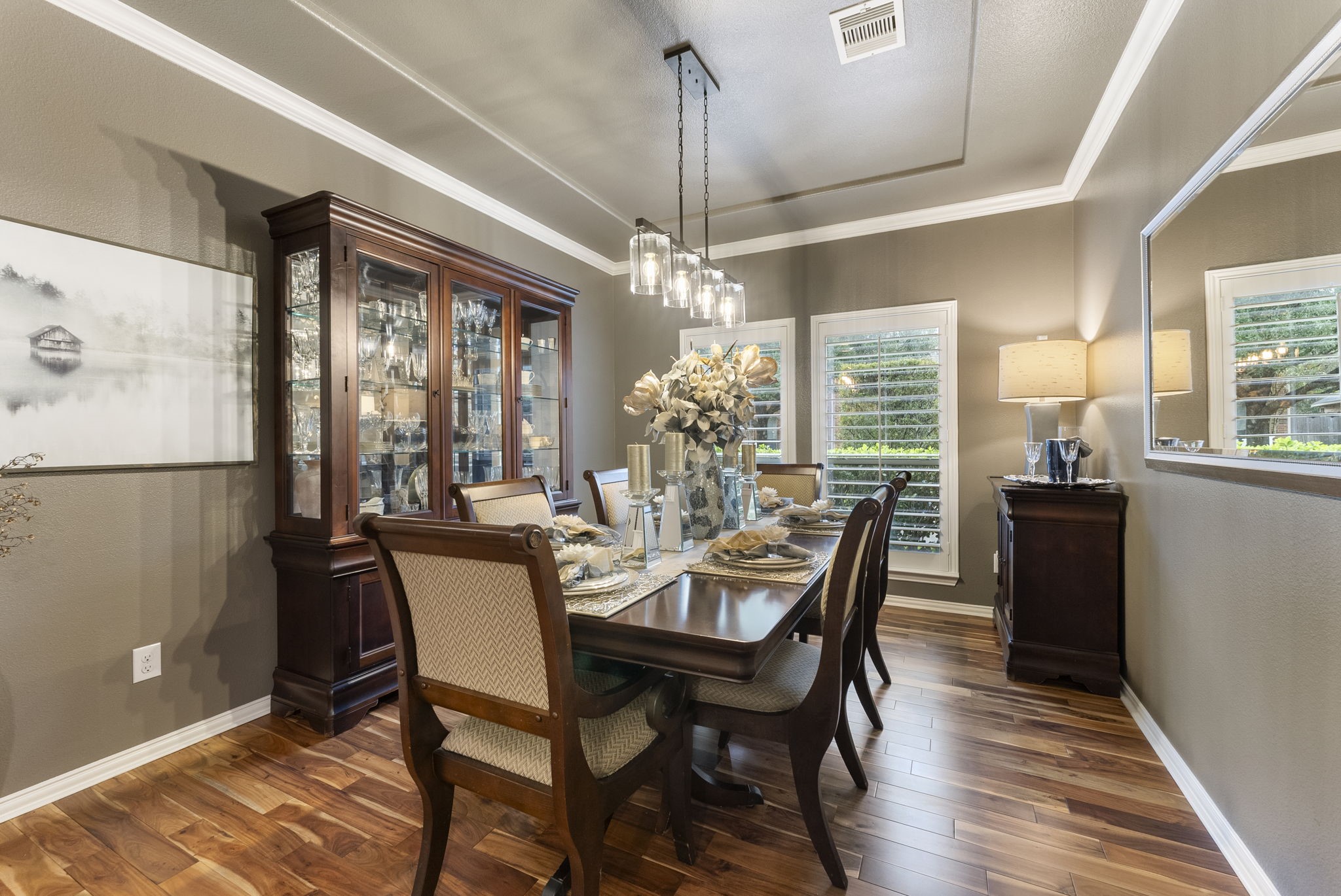 27614 Colin Springs Lane Spring, TX 77386 - Photo 9 of 47 Elegant Formal Dining showcasing wood floors, crown molding, subtle tray ceiling drop, tall windows, and an updated statement lighting fixture!