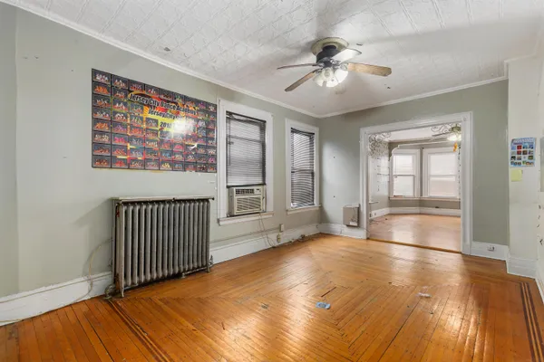 a living room with furniture and a ceiling fan