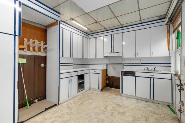 a living room with stainless steel appliances kitchen island granite countertop furniture and a flat screen tv