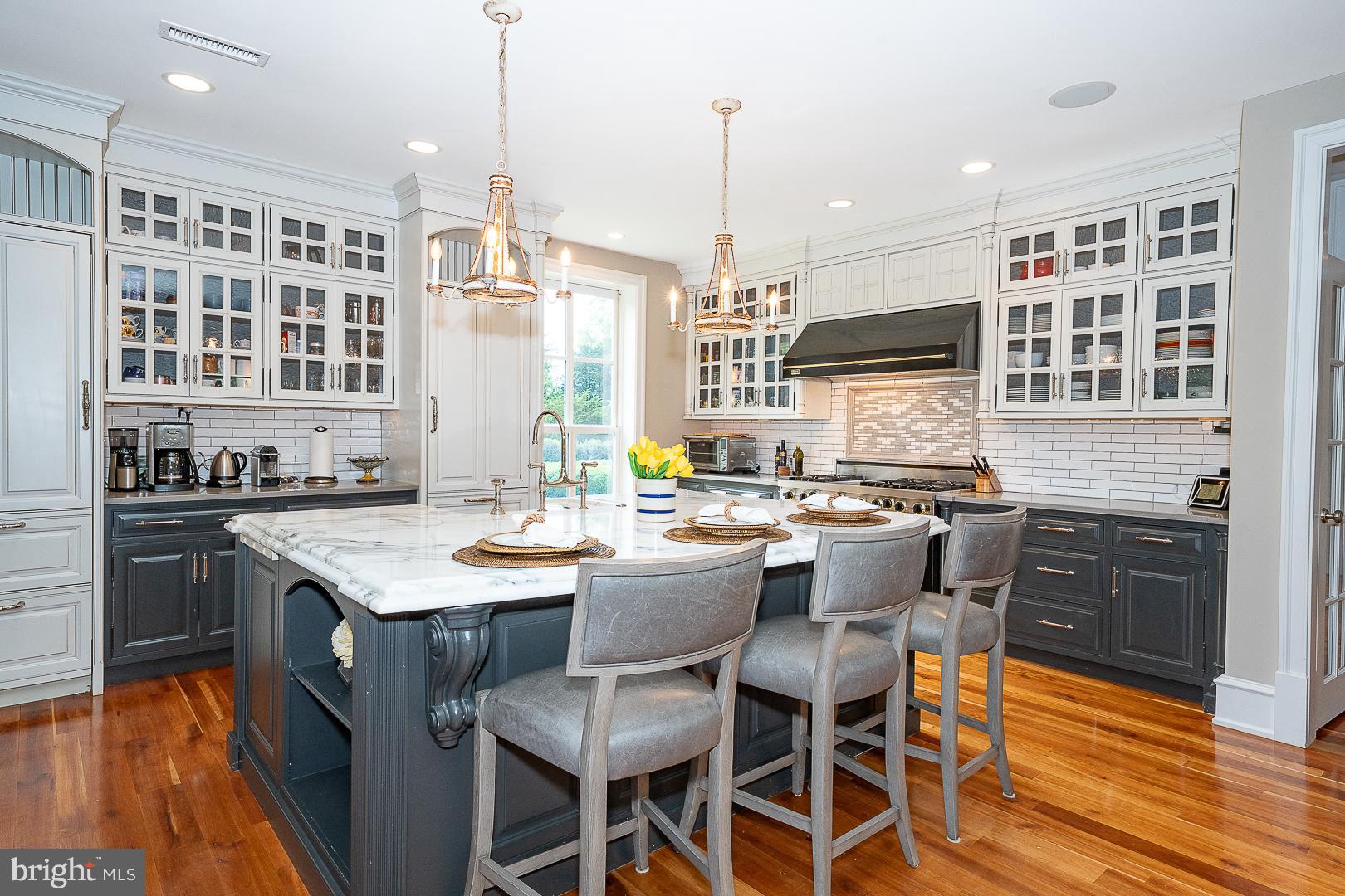 1122 Brynlawn Road Villanova, PA 19085 - Photo 6 of 46 a kitchen with a table chairs stove and wooden floor