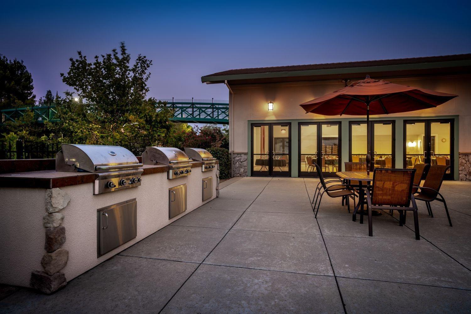 2821 Springfield Drive Rocklin, CA 95765 - Photo 38 of 43 a view of a patio with dining table and chairs under an umbrella