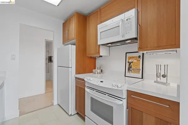 a kitchen with stainless steel appliances white cabinets and a refrigerator