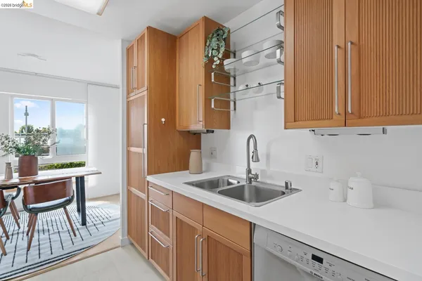 a kitchen with a sink cabinets and wooden floor