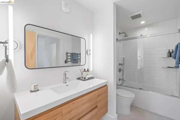 a bathroom with a sink vanity toilet and shower