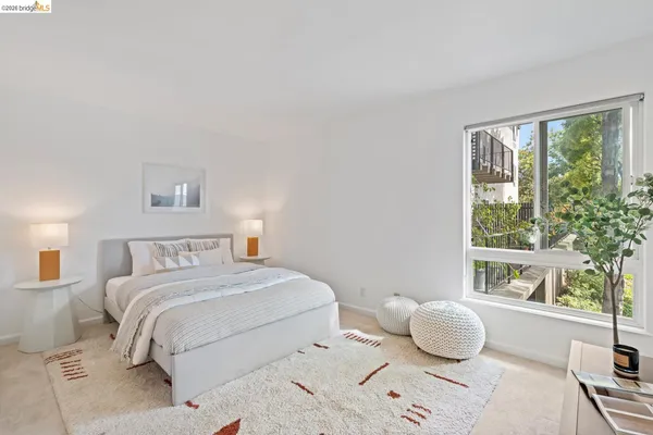 a bedroom with a bed and a large window