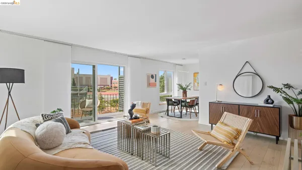 a living room with furniture a table and a large window