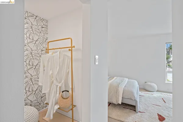 a bedroom with a bed and a mirror