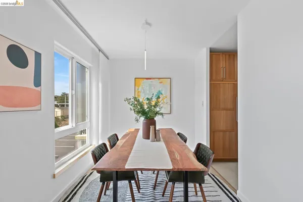 a dining room with furniture and wooden floor