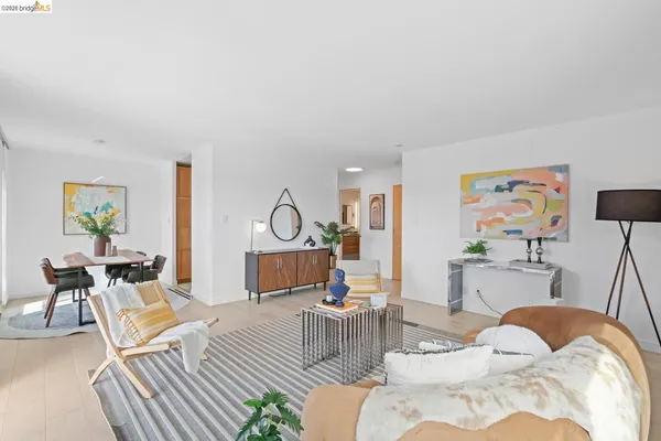 a living room with furniture a rug and white walls