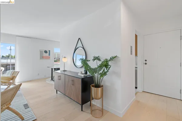 a living room with furniture and a mirror