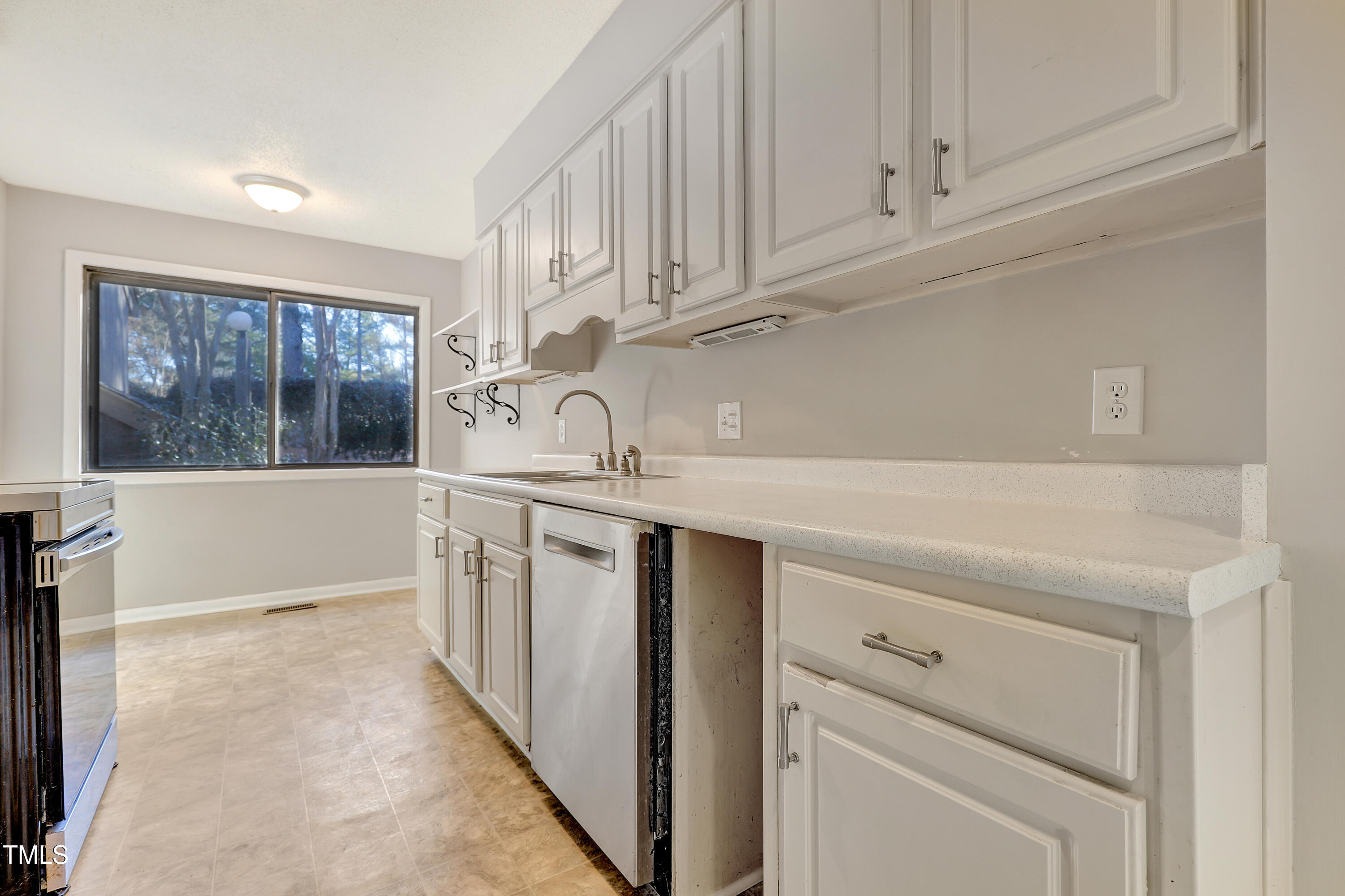 196 Ridge Trail Chapel Hill, NC 27516 - Photo 13 of 32 a kitchen with white cabinets and a sink