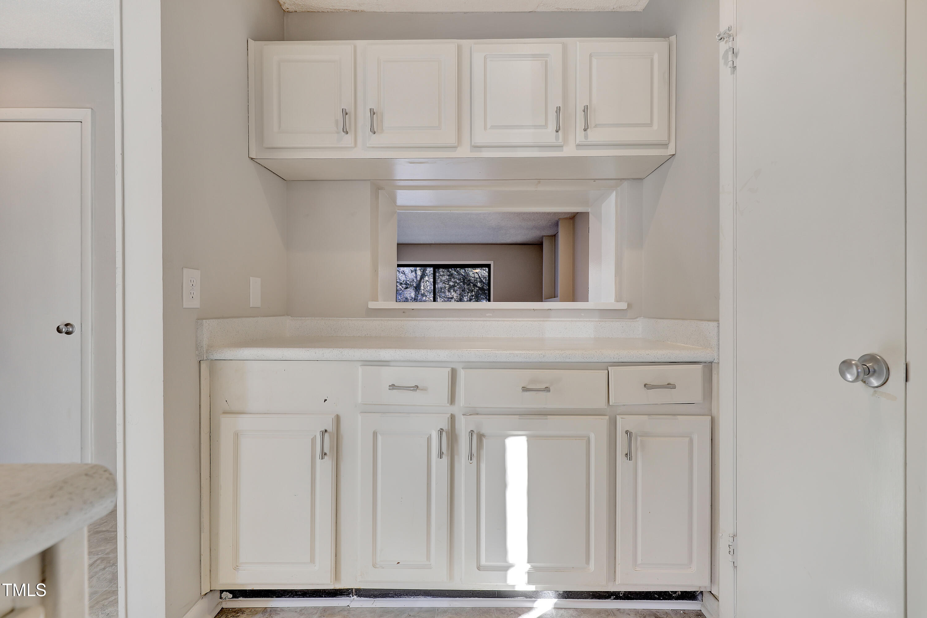 196 Ridge Trail Chapel Hill, NC 27516 - Photo 14 of 32 a kitchen with white cabinets and a refrigerator