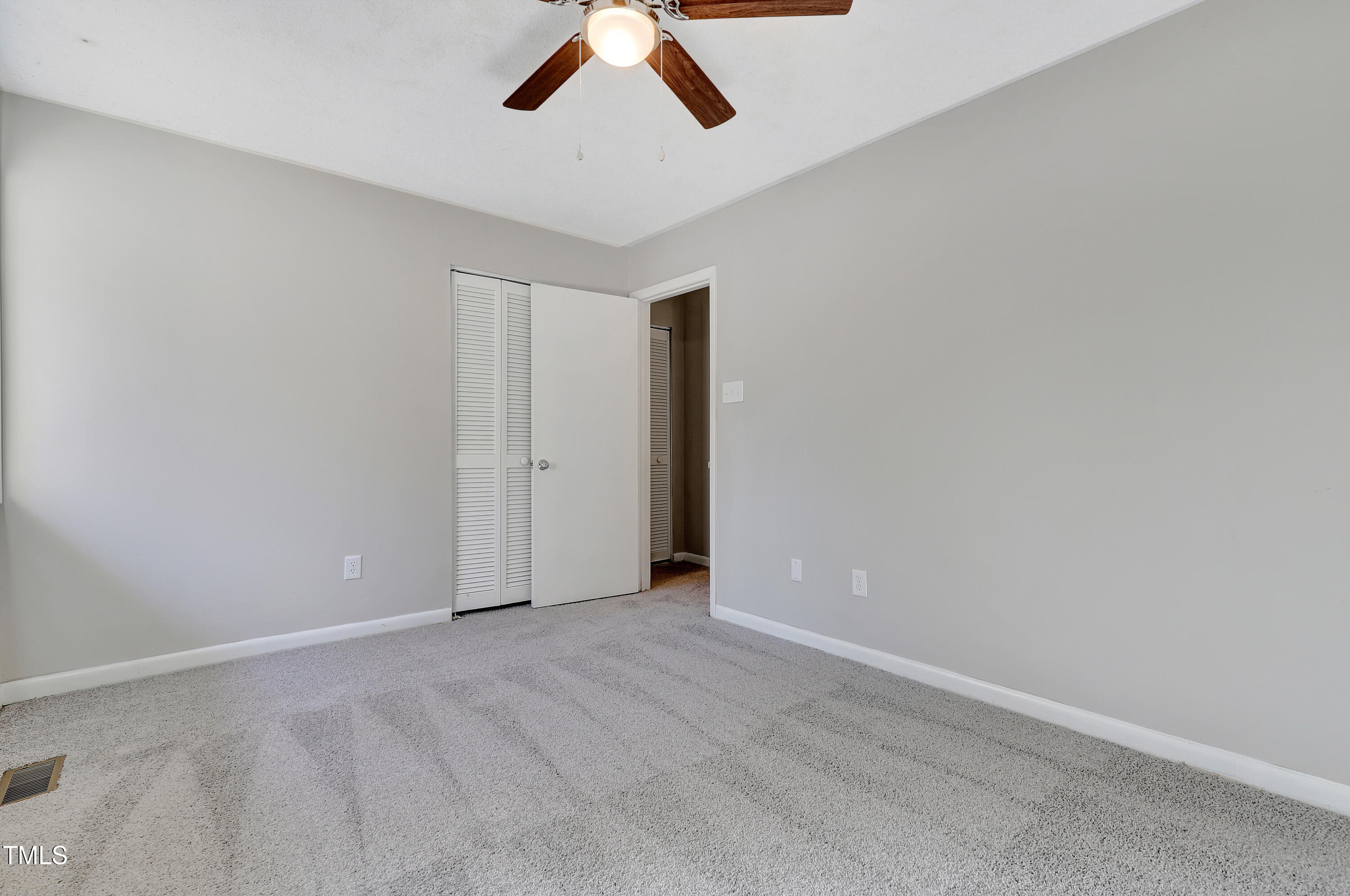 196 Ridge Trail Chapel Hill, NC 27516 - Photo 21 of 32 an empty room with ceiling fan and window