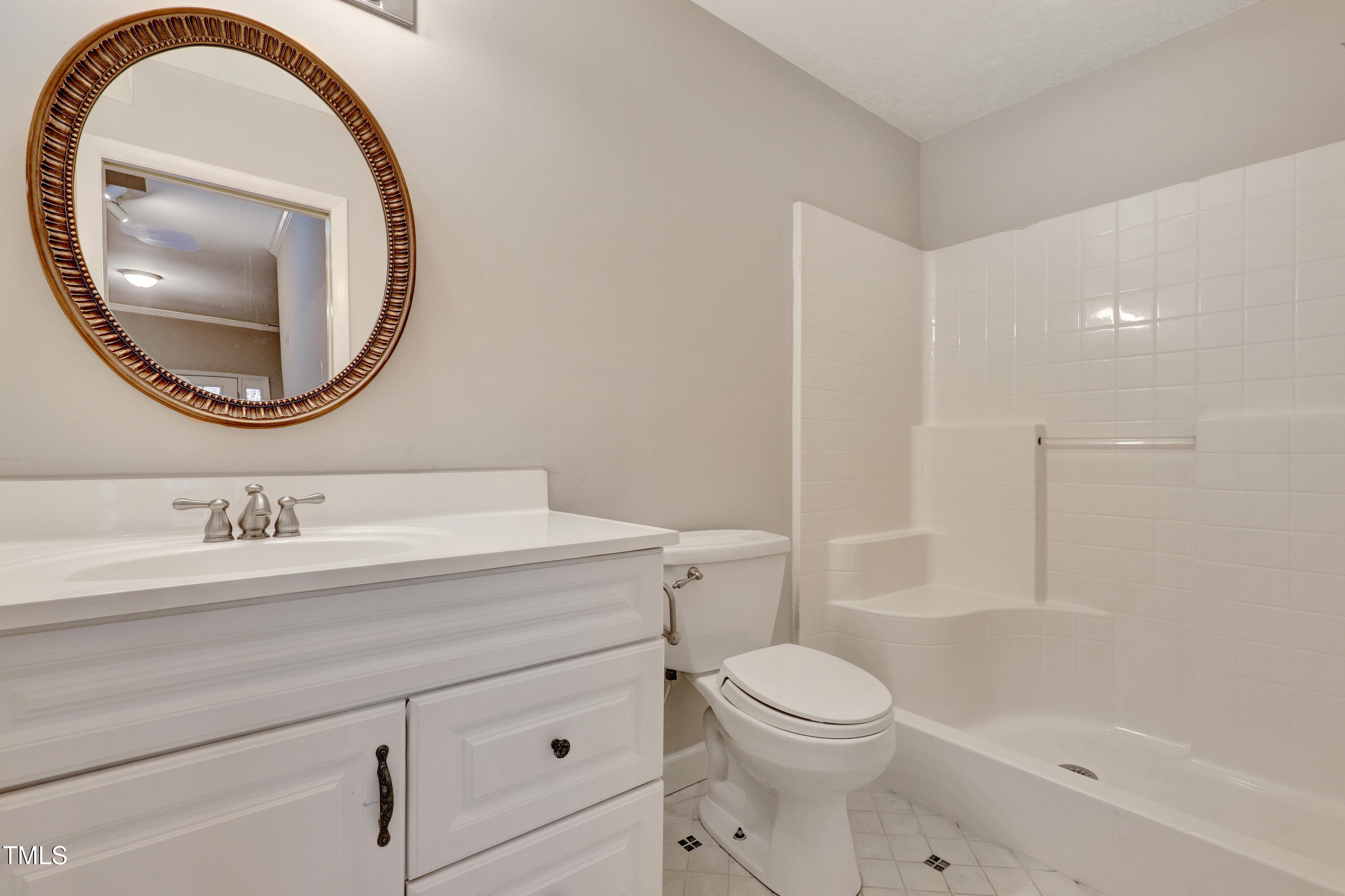 196 Ridge Trail Chapel Hill, NC 27516 - Photo 27 of 32 a bathroom with a granite countertop toilet a sink and a mirror