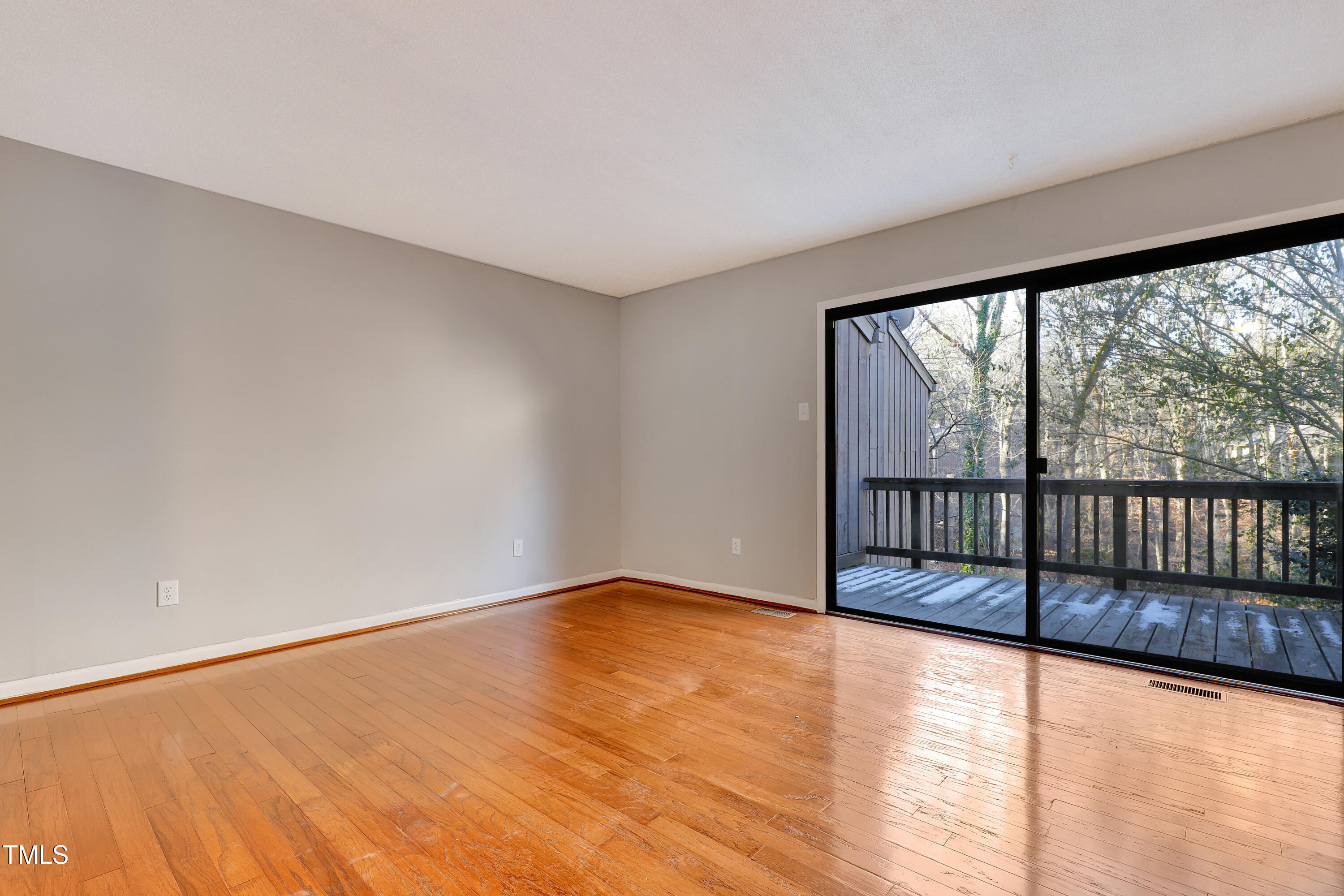 196 Ridge Trail Chapel Hill, NC 27516 - Photo 4 of 32 a view of an empty room with wooden floor and a window