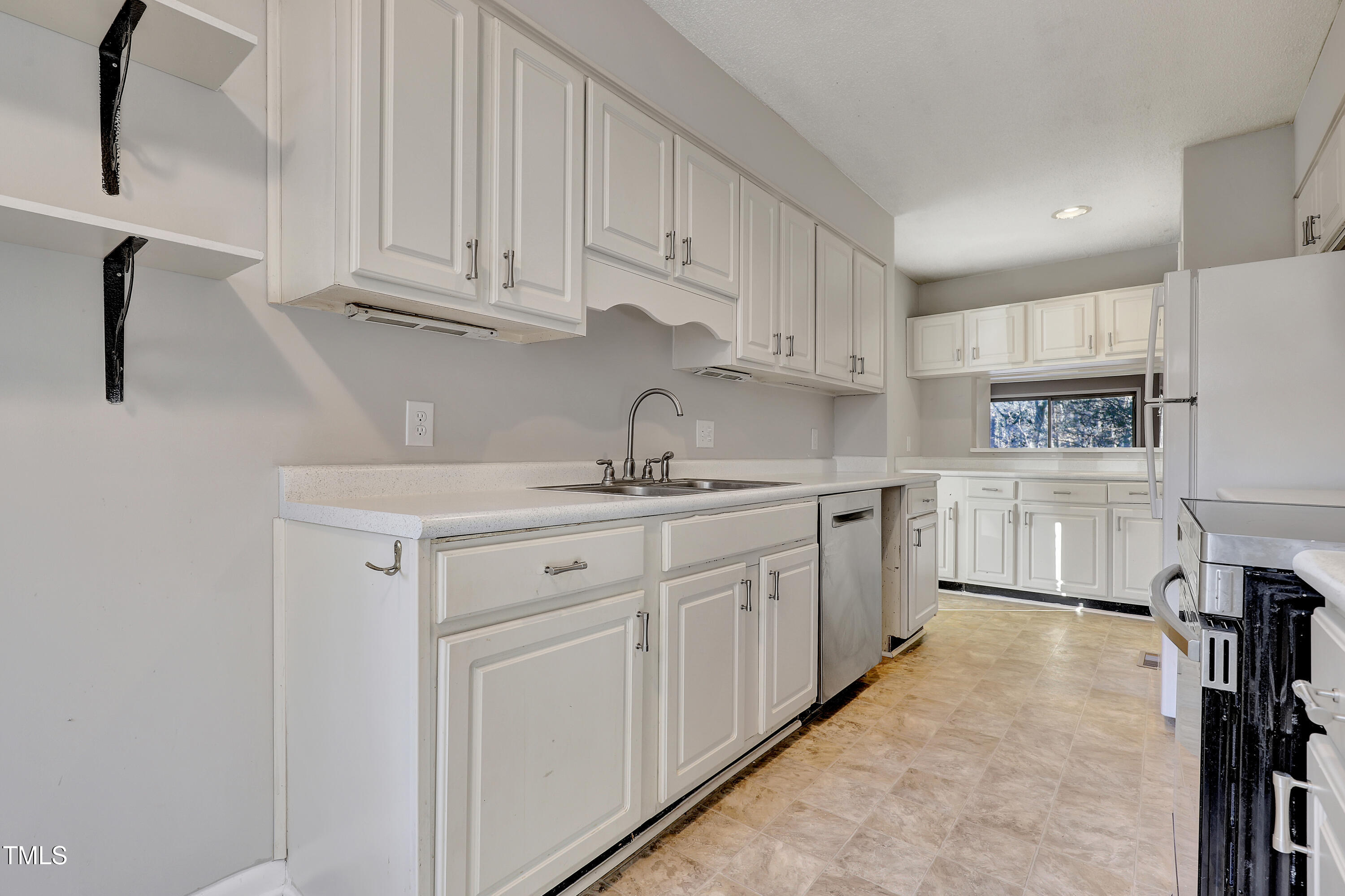 196 Ridge Trail Chapel Hill, NC 27516 - Photo 10 of 32 a kitchen with white cabinets and white appliances