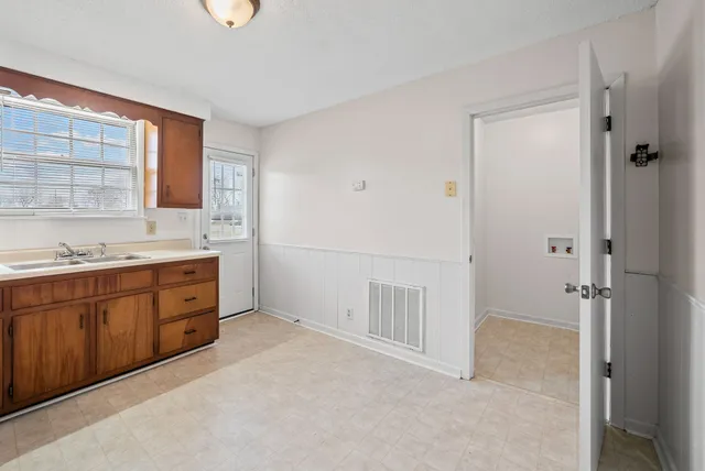 a spacious bathroom with a granite countertop sink mirror and a