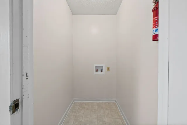 a kitchen with a refrigerator sink and cabinets