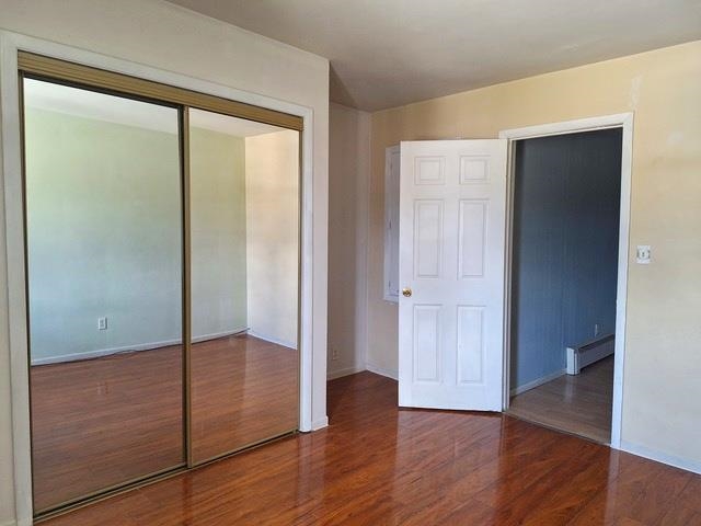506 Main Street Marseilles, IL 61341 - Photo 7 of 10 an empty room with wooden floor and door