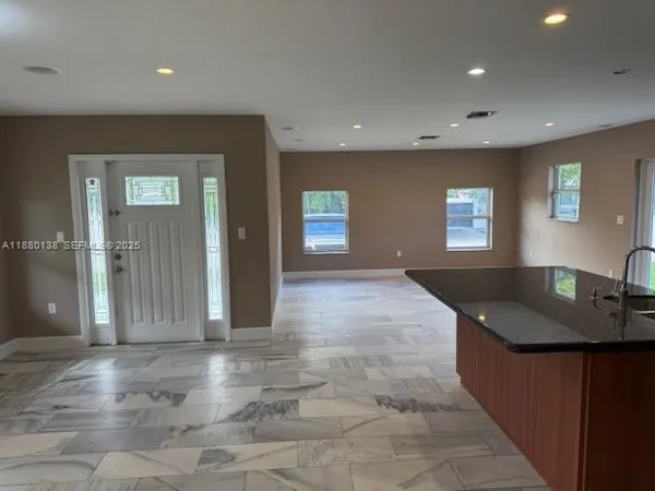 a kitchen with granite countertop sink and cabinets