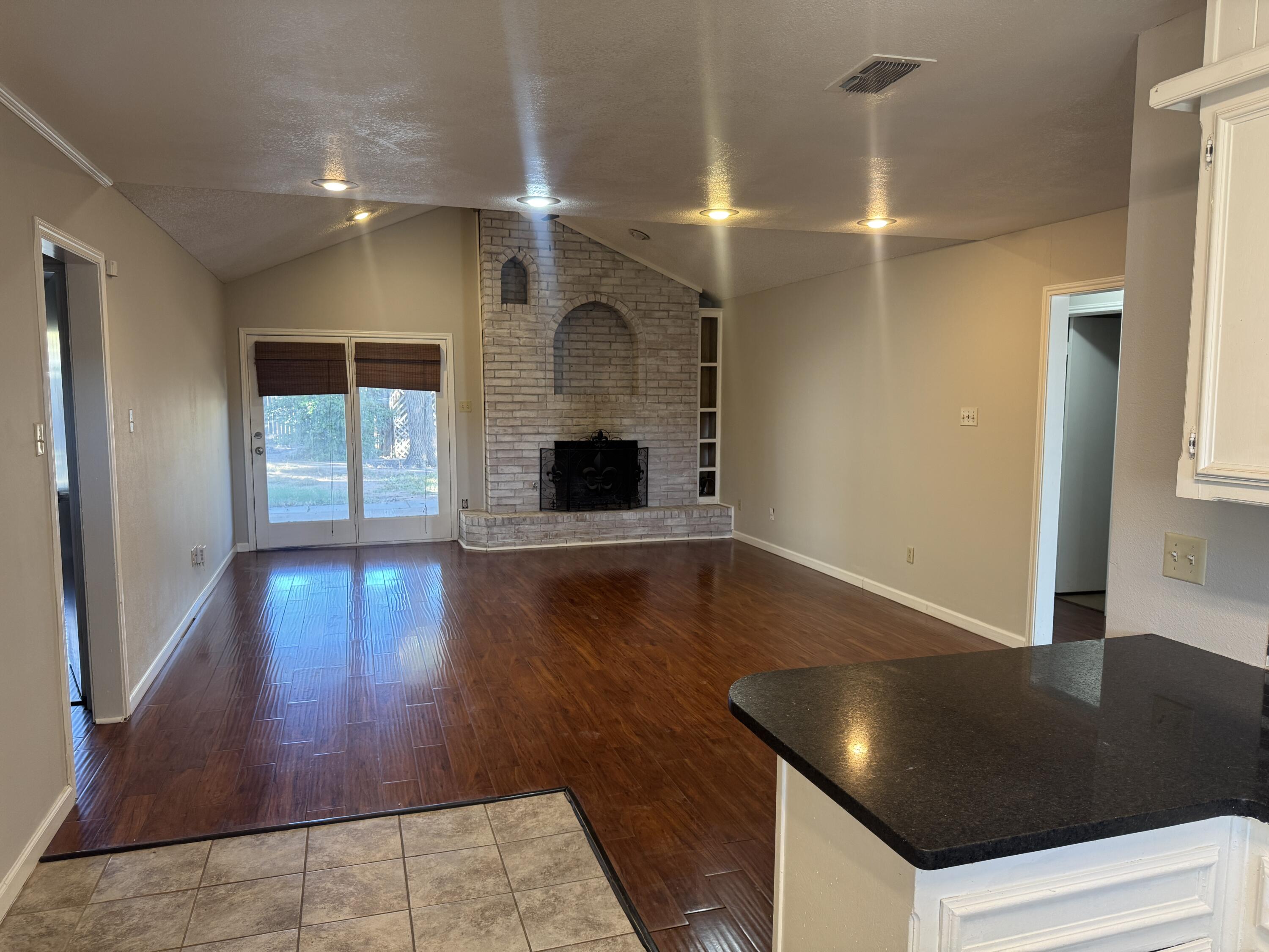 4932 63rd Street Lubbock, TX 79414 - Photo 3 of 14 a view of a livingroom with wooden floor and staircase