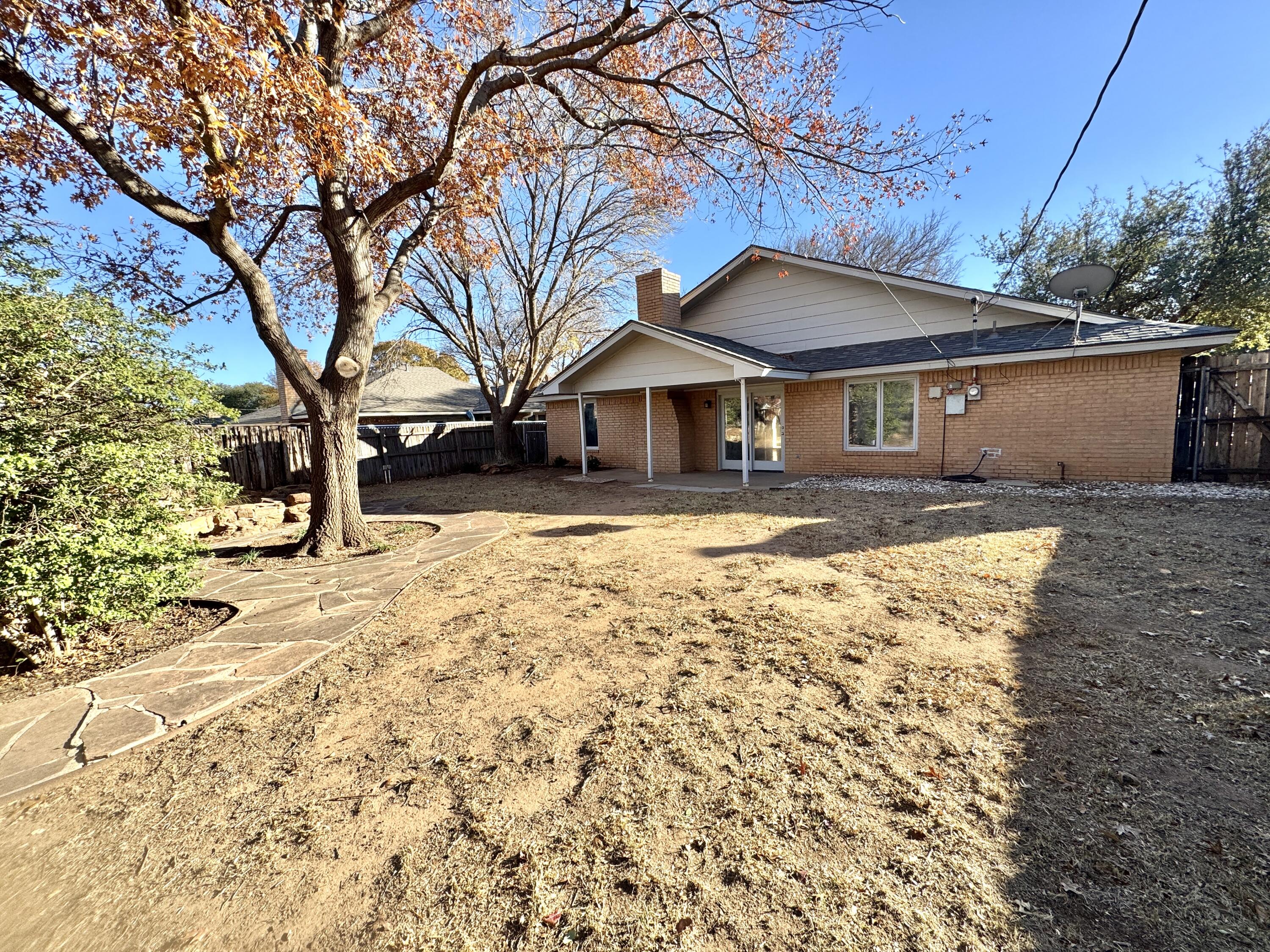 4932 63rd Street Lubbock, TX 79414 - Photo 4 of 14 front view of a house with a yard