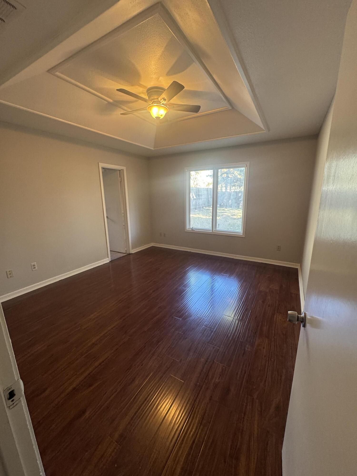 4932 63rd Street Lubbock, TX 79414 - Photo 6 of 14 an empty room with wooden floor and windows
