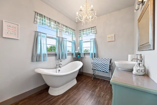 a view of a dining room with furniture wooden floor and chandelier
