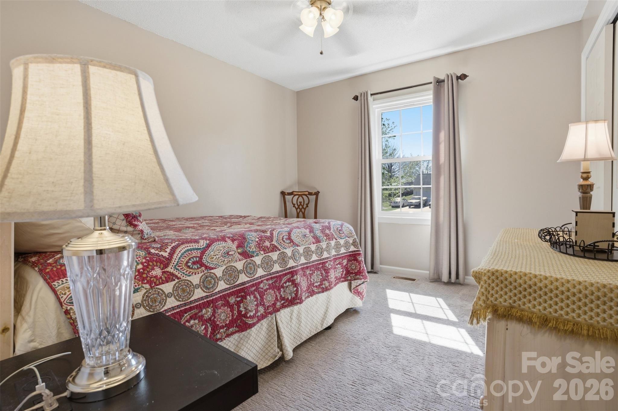 3918 Plum Street Conover, NC 28613 - Photo 13 of 31 a bedroom with a bed and a chandelier