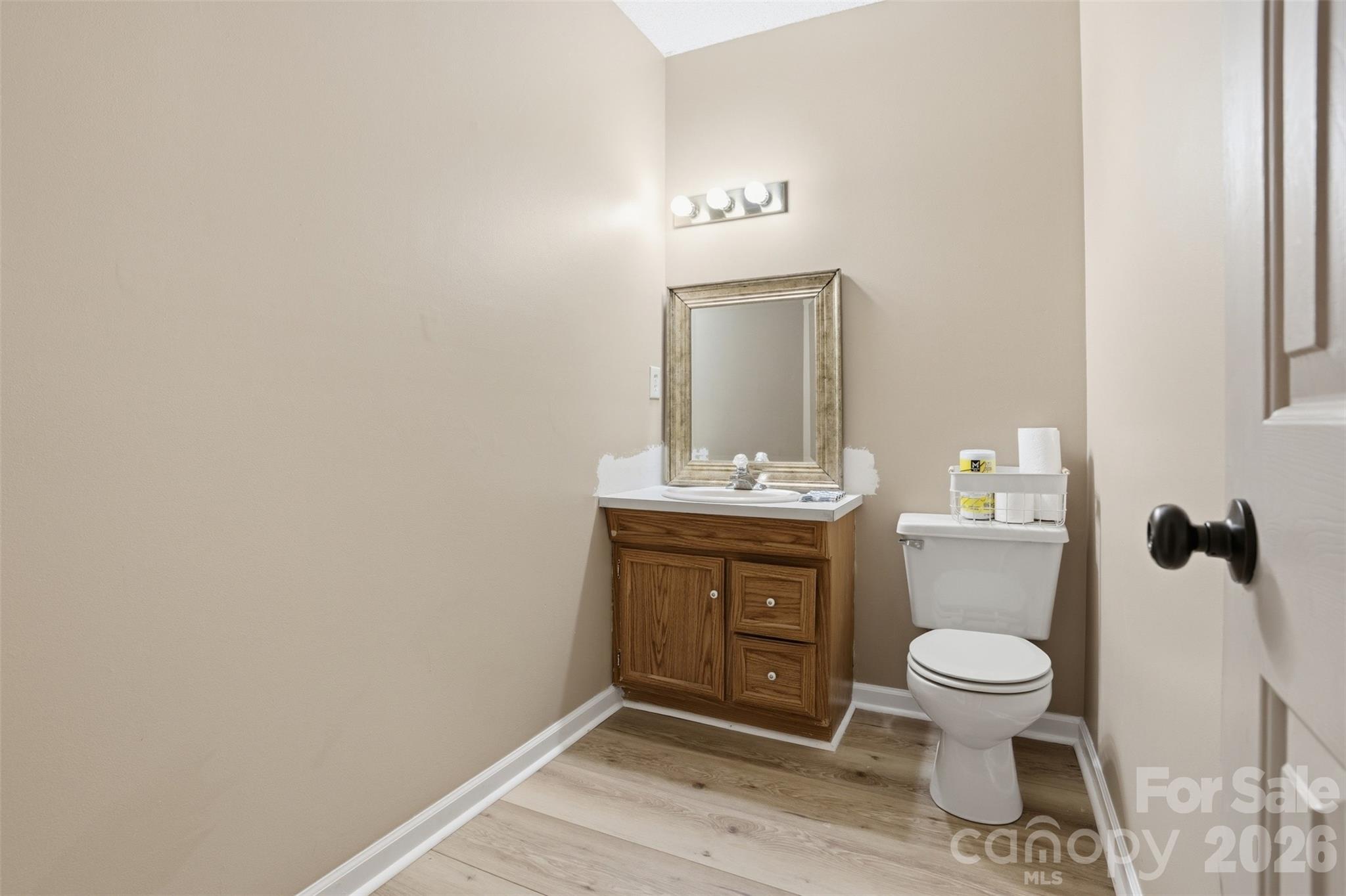 3918 Plum Street Conover, NC 28613 - Photo 22 of 31 a bathroom with a toilet a sink and mirror