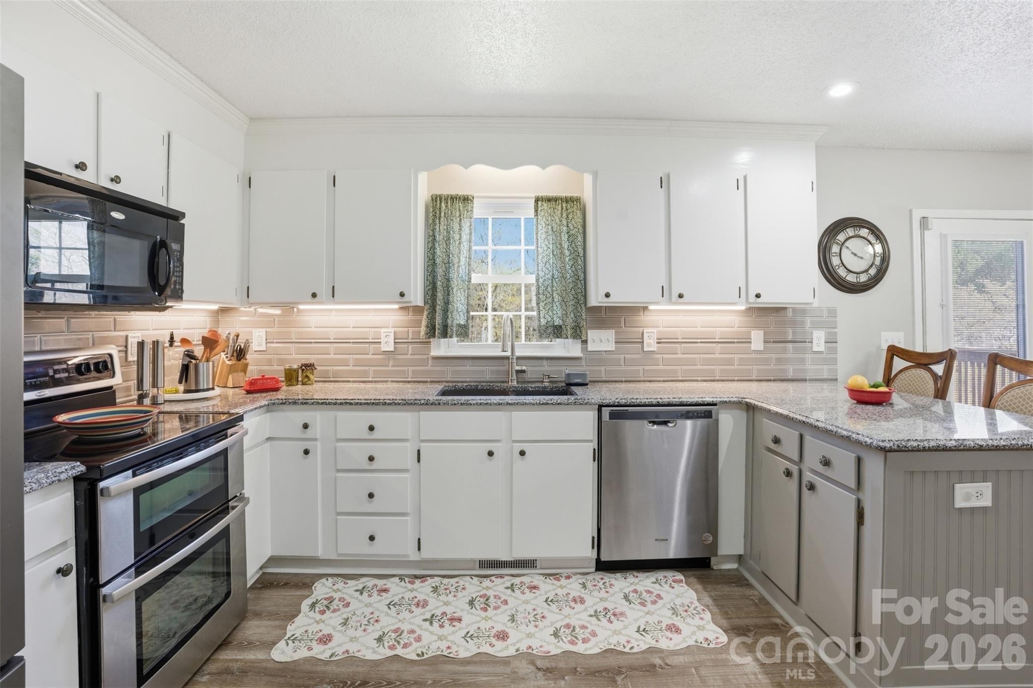 3918 Plum Street Conover, NC 28613 - Photo 6 of 31 a kitchen with granite countertop a sink a stove and cabinets
